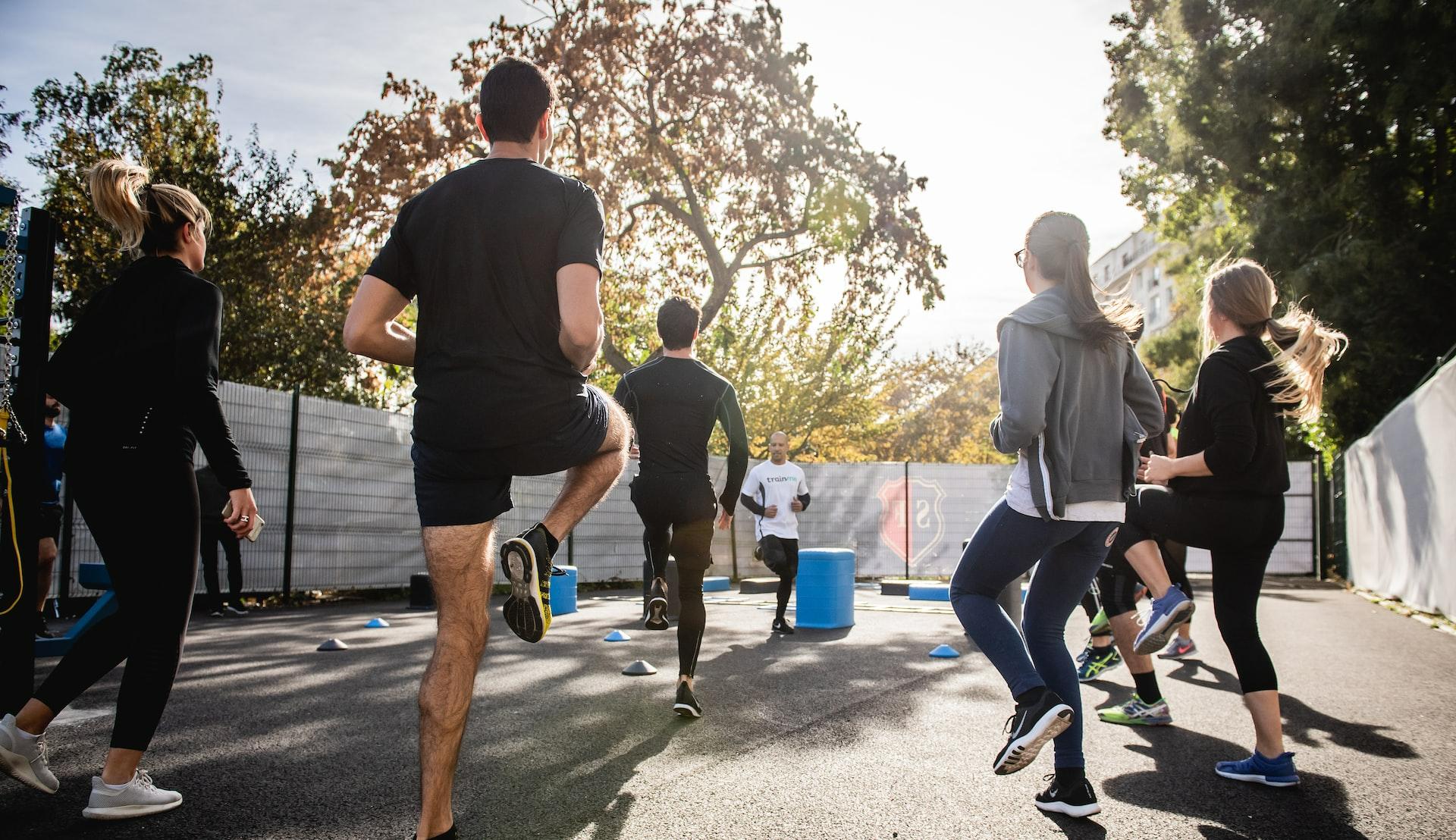 man in black t-shirt and black shorts running on road during daytime